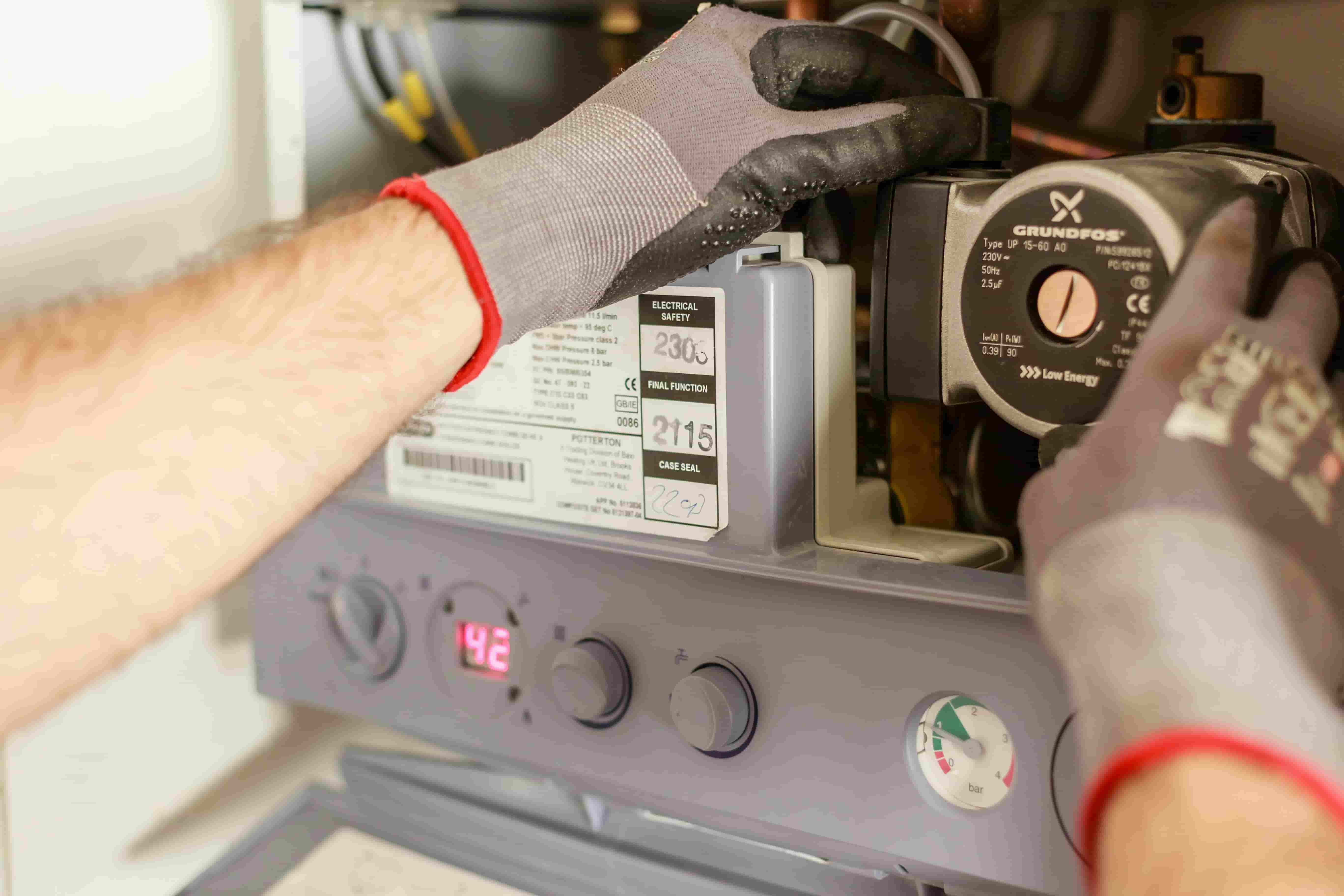 Gas Safe engineer repairing boiler